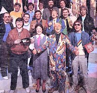  (L-R from back;) Richard Skinner, Gary Davies, Tommy Vance, Dave Lee Travis, (Centre row;) Andy Peebles, Peter Powell, Tony Blackburn, Mike Smith, Paul Gambaccini, Pat Sharp, (front row;) Simon Bates,  Janice Long, Sir Jimmy Savile and Adrian John. Photograph taken during recording of the Top of the Pops  1000th edition, in May 1983.